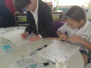 Jon and Laura record observations about the beans they have prepared for germination.